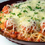 Cheesy Spaghetti Pie Delight with Rich Marinara Sauce